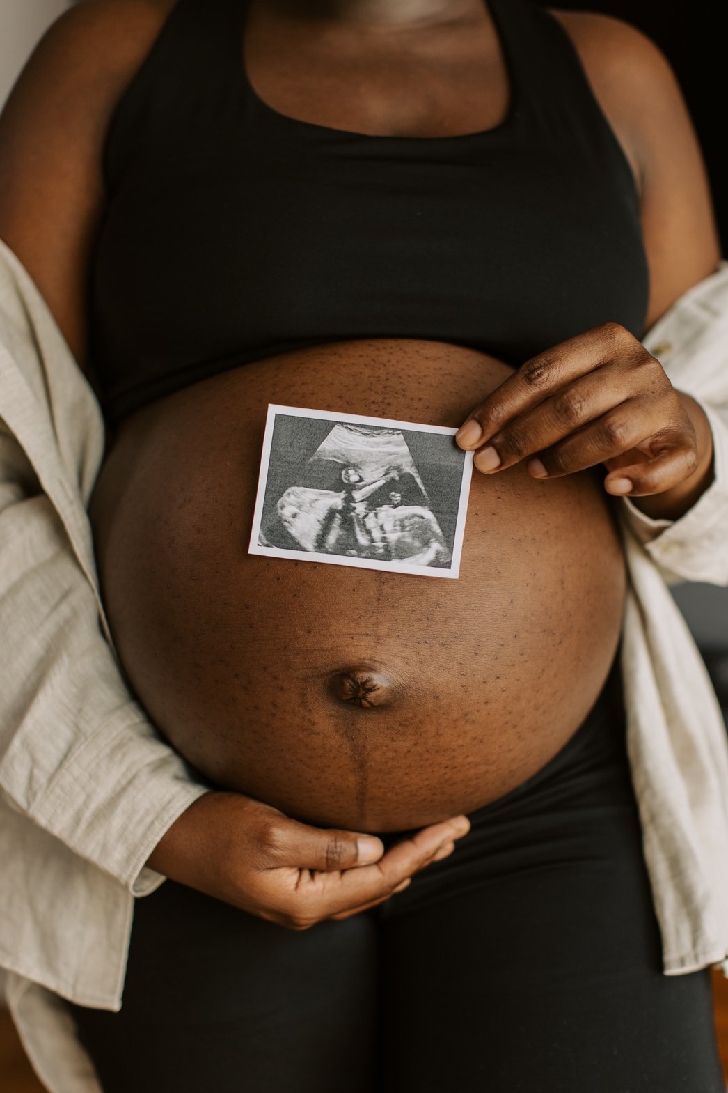 Pregnancy at Home Woman Holding Ultrasound Photo